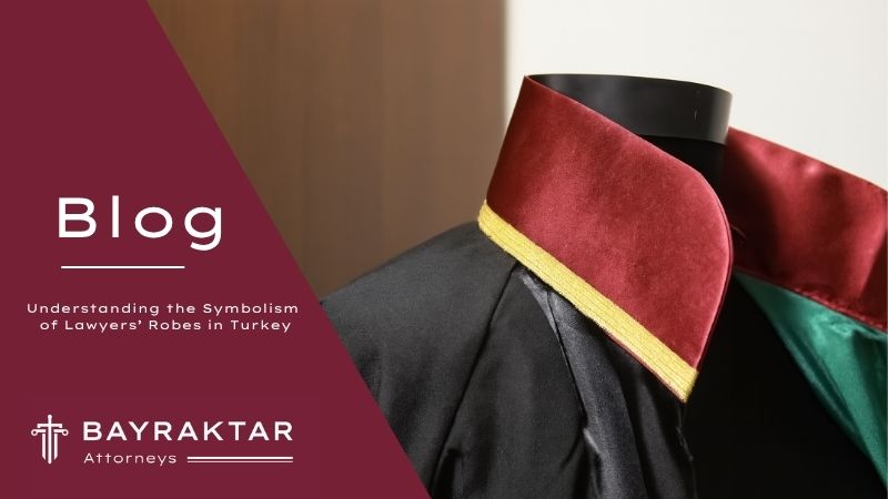 A digital photograph provides a close-up view of a traditional Turkish lawyer's robe, featuring a black body with a distinctive red and green collar, symbolizing legal authority and professionalism in Türkiye.