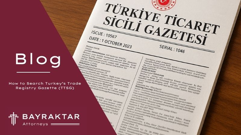A digital photograph displays a printed copy of the Türkiye Trade Registry Gazette (Ticaret Sicil Gazetesi) dated 1 October 2023, placed on a wooden surface. The left side of the image features a maroon overlay with the Bayraktar Attorneys logo and the blog title.